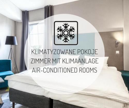 a bedroom with a bed with a sign that reads kimrinphrinephrinerole at Hotel Kaliski in Słubice