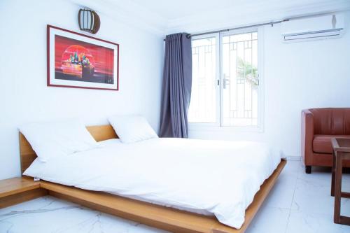 Ein Bett oder Betten in einem Zimmer der Unterkunft Villa Somone pied dans l’eau