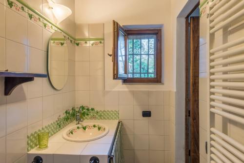 a bathroom with a sink and a window at Casina di Teo by VacaVilla in Monteriggioni