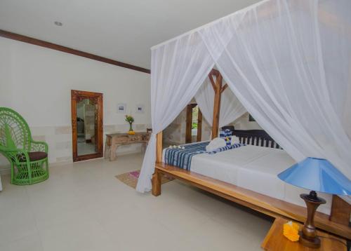 Ένα ή περισσότερα κρεβάτια σε δωμάτιο στο Villa Kami Ubud
