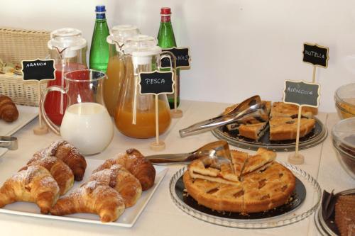 a table with various pastries and breads on plates at Masseria Relais Santa Teresa in Sannicola
