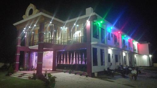 a building with colorful lights on it at night at Hotel the Ideal in Kushinagar