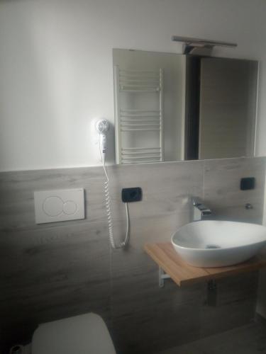 a bathroom with a sink and a mirror at UP&B Rooms Catania in Mascalucia