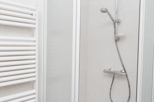 a shower with a shower head in a bathroom at Hello Zeeland - Appartement Port Scaldis 13-111 in Breskens