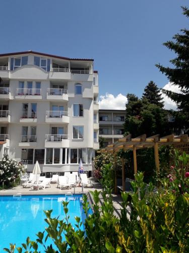 a hotel with a swimming pool in front of a building at Villa Jordan in Ohrid
