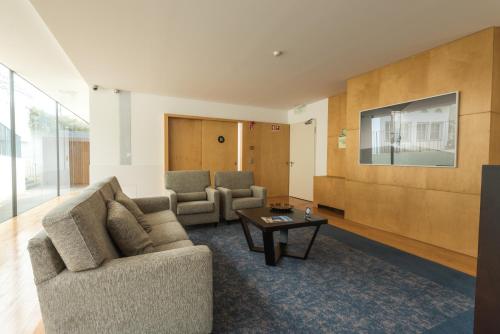a living room with a couch and a table at ARTS IN Hotel Conde Carvalhal in Funchal