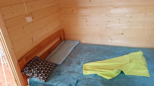 a small room with a mattress and two pillows at Osada nad Szumem in Józefów