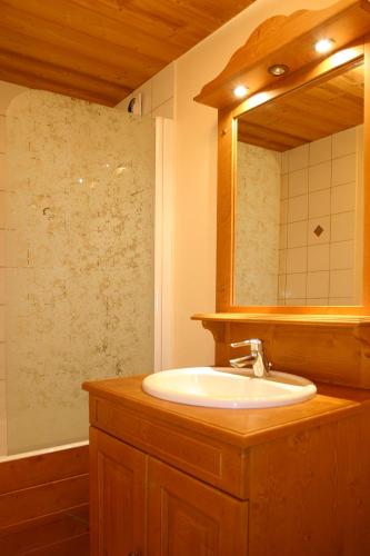 a bathroom with a sink and a mirror at Vacancéole - Résidence Plein Sud in Les Deux Alpes