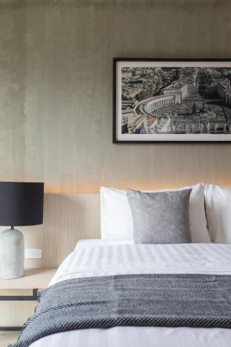 a bedroom with a bed and a picture on the wall at The Journey Hotel Bangna in Samut Prakan