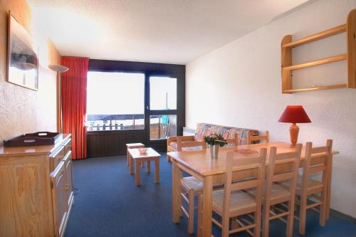 a kitchen and dining room with a table and chairs at Vacancéole - Résidence Plein Sud in Les Deux Alpes