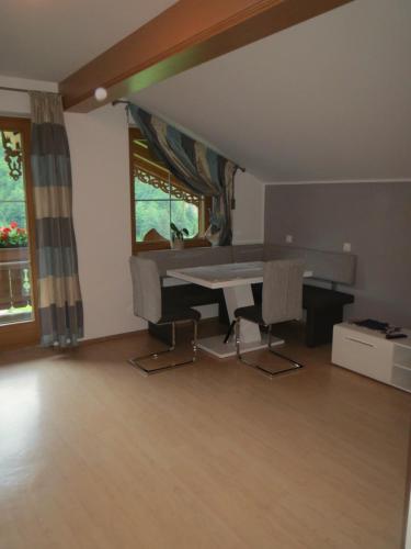 a living room with a table and a window at Ascherhof in Auffach