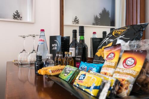 a table topped with bottles of wine and snacks at ARTS IN Hotel Conde Carvalhal in Funchal