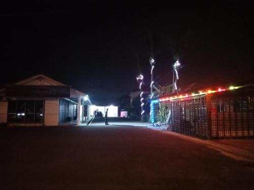 an empty street at night with lights on a building at Inapan Desa Homestay Kangar Perlis in Kangar