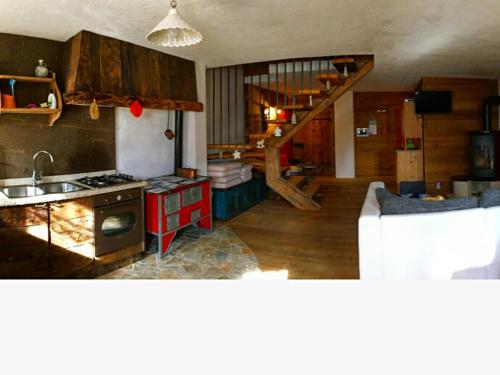 a kitchen with a stove and a couch in a room at Chalet Lagorai in Roncegno