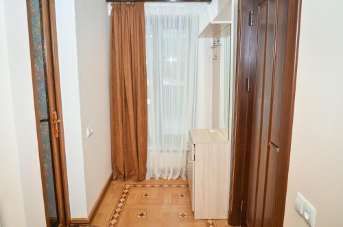 a hallway with a window and a wooden floor at Rubin Hotel in Goris