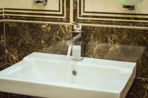 a bathroom sink with a faucet on top of it at Rubin Hotel in Goris