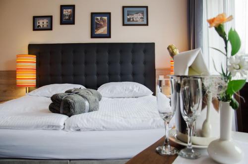 a bedroom with a bed with a black headboard at Pokoje gościnne WiP in Cieszyn