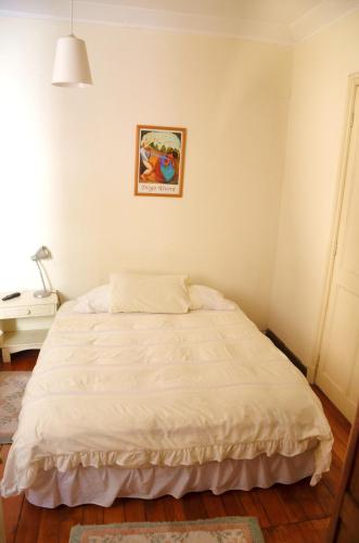 a bed in a bedroom with a picture on the wall at Tralkan B&B in Santiago
