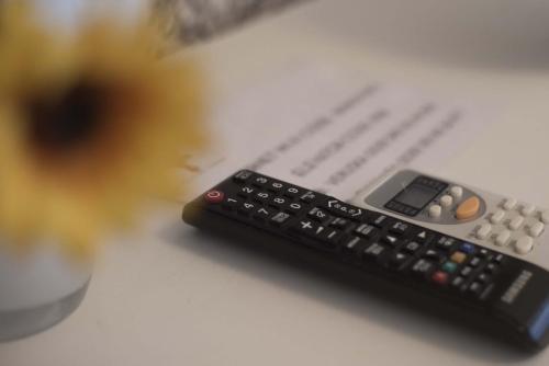 two remote controls sitting on top of a table at Barberini Dream in Rome