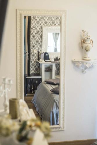 a bedroom with a bed and a mirror at Barberini Dream in Rome