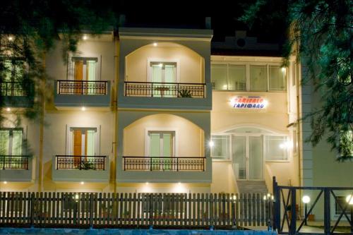 a large white building with a sign on it at Garifalo Apartments in Kalyves
