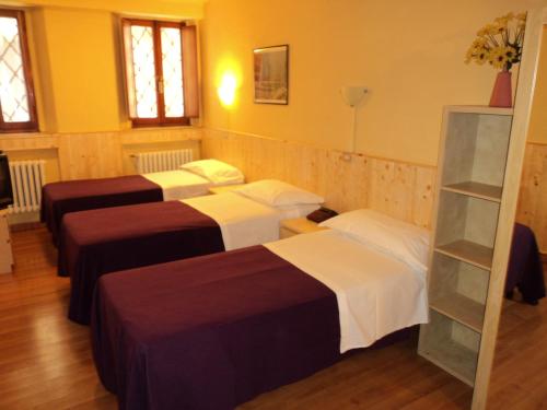 A bed or beds in a room at Hotel Ariosto centro storico