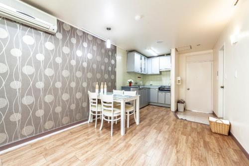 a kitchen and dining room with a table and chairs at HK Resort in Sokcho