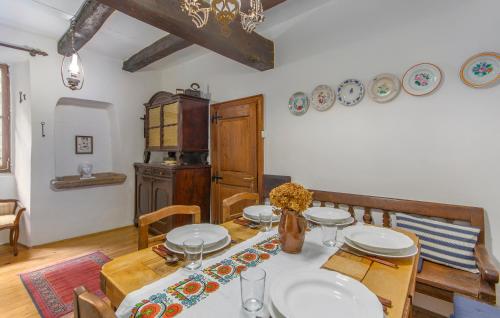 a dining room with a table with plates on it at Apartment Kuharić in Grožnjan