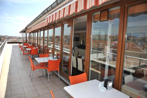 a restaurant with tables and chairs on a balcony at Saray Hotel in Edirne