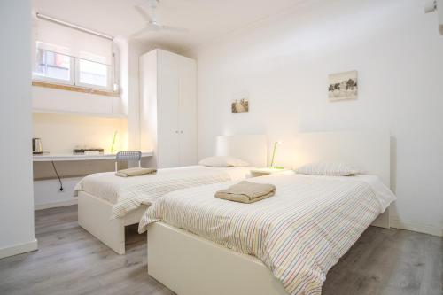 En eller flere senge i et værelse på Tagus 5 Colours Suites