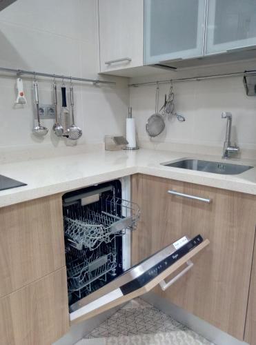 a kitchen with a dish rack in an oven at Apartamento centrico en Lekeitio, playa y puerto in Lekeitio
