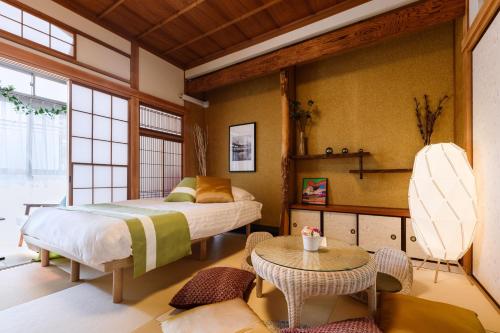 a bedroom with a bed and a table at Suiren Residential Suite Tokyo in Tokyo