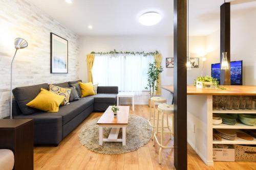 a living room with a couch and a table at Suiren Residential Suite Tokyo in Tokyo