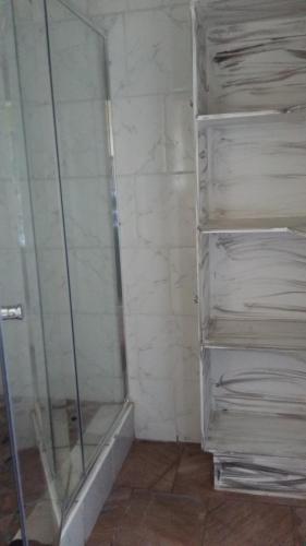 a bathroom with a shower with a glass door at Arek's Place in Krugersdorp