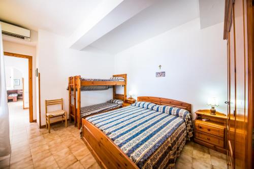a bedroom with a bed and a dresser in it at Casa MARINELLA in Lipari