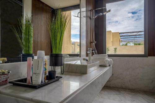 a bathroom with a sink and a large window at Marrakech Holiday in Marrakesh