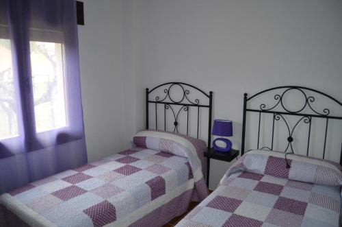 A bed or beds in a room at Apartamentos La Eliza