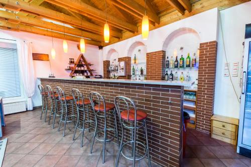 a row of stools at a bar in a restaurant at Penzion Forest in Rozvadov
