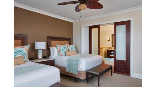 a bedroom with two beds and a ceiling fan at Cheeca Lodge & Spa in Islamorada