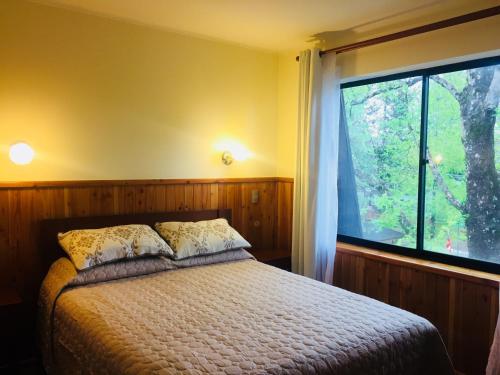 Ένα ή περισσότερα κρεβάτια σε δωμάτιο στο Departamento Pucón