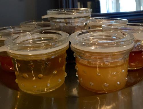 a group of jars of honey on a table at Quai 17 Maison d'hôtes in Strasbourg