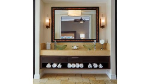 a bathroom with a mirror and a sink at Cheeca Lodge & Spa in Islamorada
