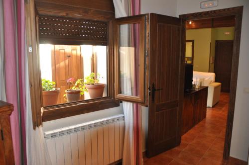 um quarto com uma janela com vasos de plantas em Casa Rural El Abuelo Quiko em Chinchón