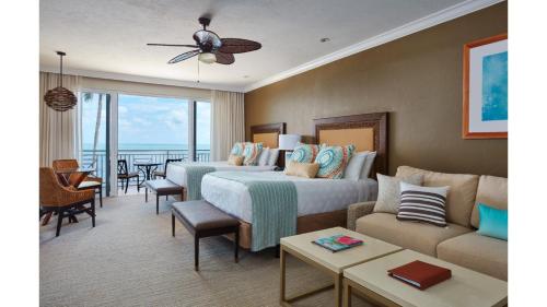 a hotel room with a bed and a couch at Cheeca Lodge & Spa in Islamorada