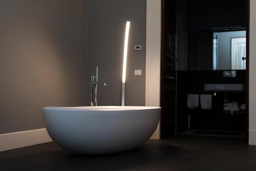 a white bath tub sitting in a bathroom at Foro Carolino S&B in Naples