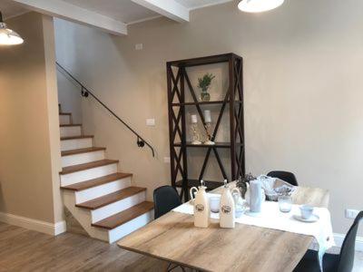 a dining room with a table and a staircase at White House in Cagliari
