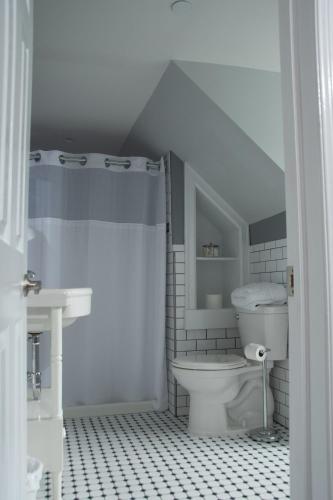 a bathroom with a toilet and a sink at The Ocean Bay House in Bay Shore