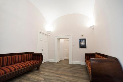 a living room with two leather couches and a hallway at Foro Carolino S&B in Naples