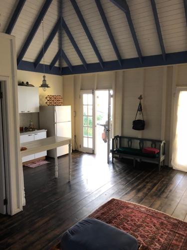 a large living room with a table and a couch at Breeze Cottage in Five Islands Village