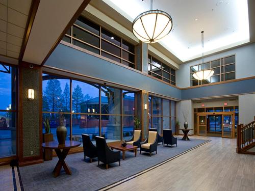 an empty lobby with chairs and tables and windows at Bally's Evansville Casino & Hotel in Evansville